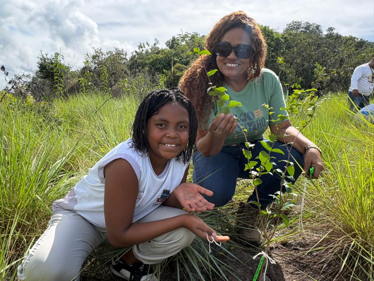 Estudante e mulher durante plantio de mudas nativas nas Dunas de Jauá, em Camaçari, na programação do EcoJunho 2026